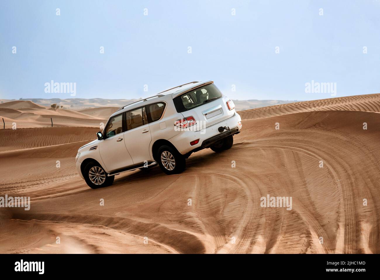 Dubai, United Arab Emirates - 01, July 2021 : The car ride at Arabian Desert over the dunes. A warm day in the desert. Stock Photo