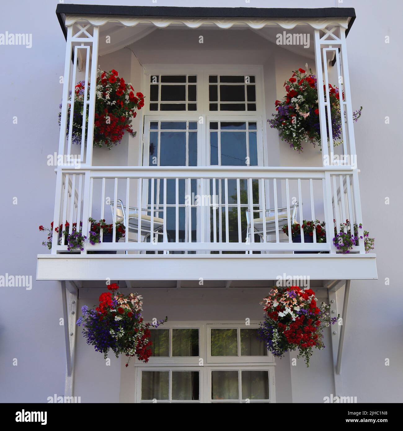 Beautiful balcony with hanging baskets Stock Photo