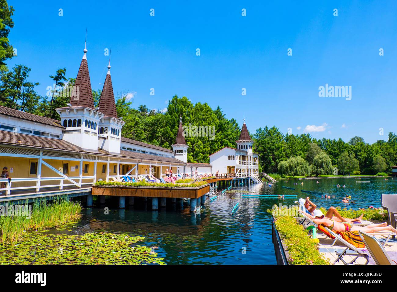 People by the wooden pavilions, at thermal lake, Heviz, Hungary Stock Photo