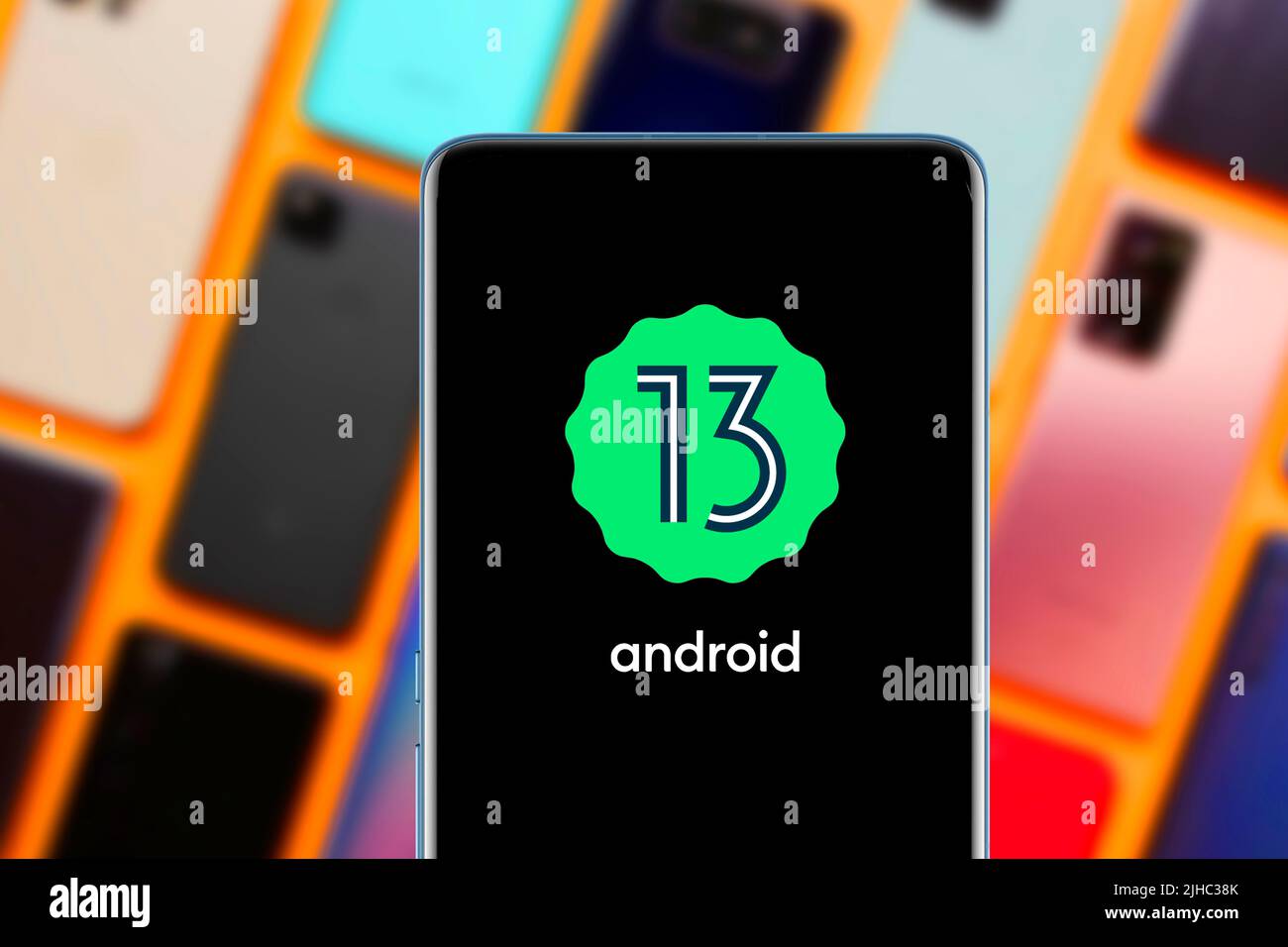 Android 13 logo and mobile interface on a smartphone screen. This ...