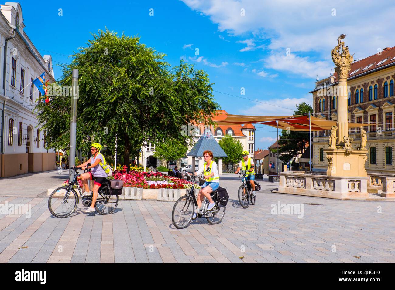 Cyclists, Fö ter, main square, Keszthely, Hungary Stock Photo