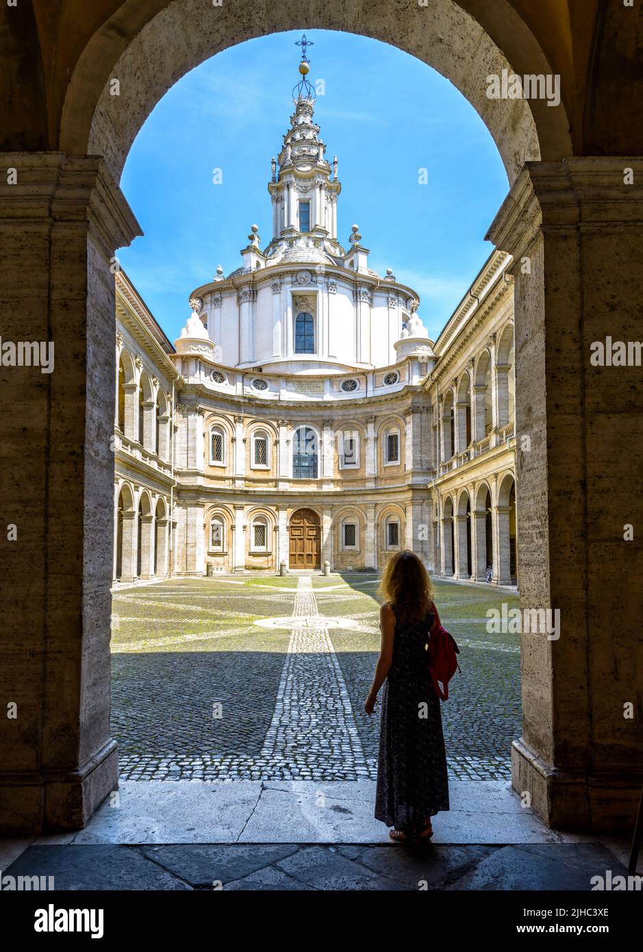 Church of Saint Yves at La Sapienza, Rome, Italy. Girl tourist visits former University of Rome. Person, young woman looks at city landmark. Concept o Stock Photo