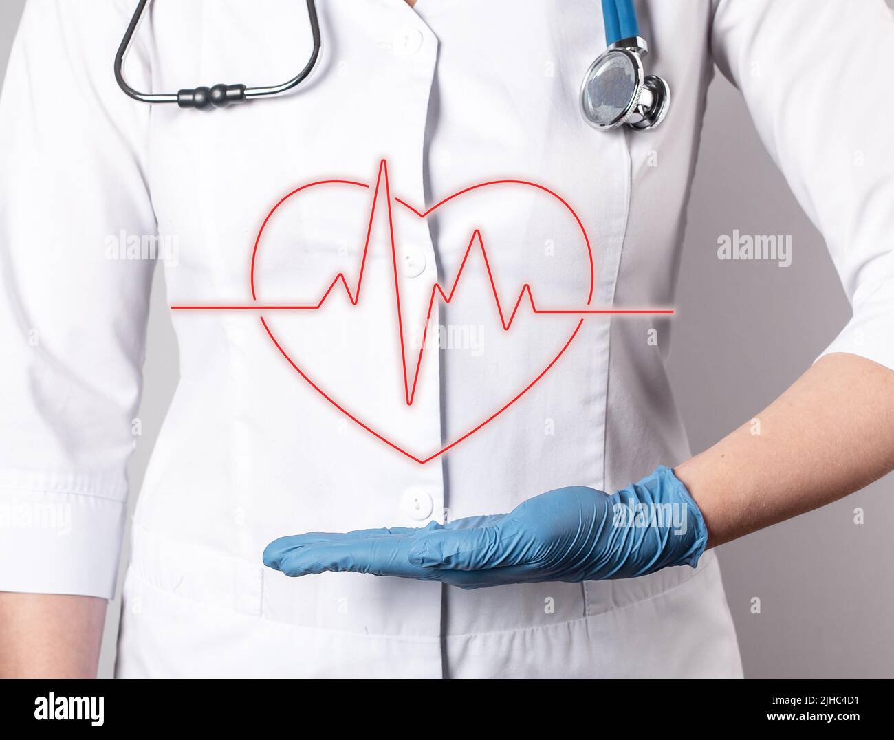 ECG. Heart with heartbeat rhythm over doctor hand. Electrocardiogram test conducting, cardiac diseases detection concept. Woman in lab coat with stethoscope. High quality photo Stock Photo