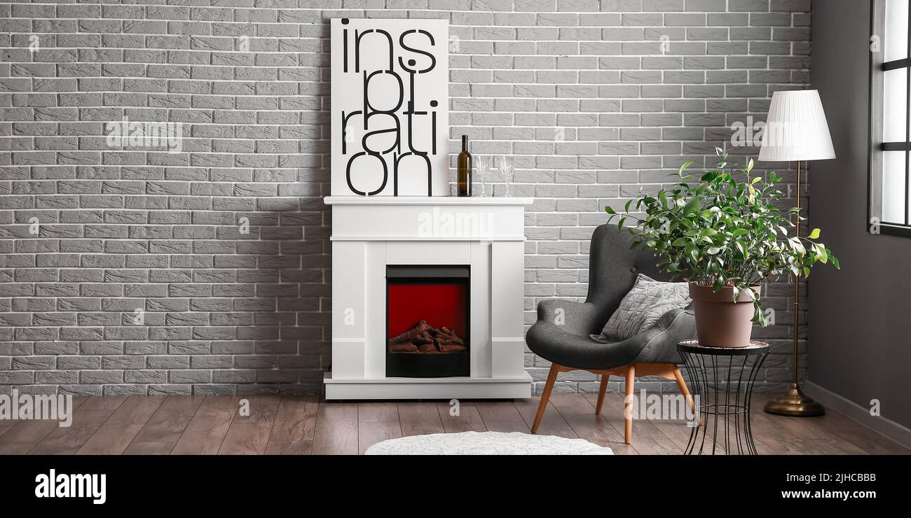 Interior of modern living room with armchair, houseplant and fireplace ...