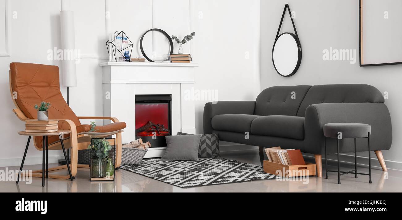 Interior of modern living room with fireplace, sofa and armchair Stock ...