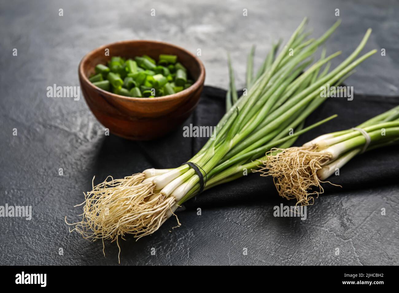 Bunches of green onion on dark background Stock Photo - Alamy