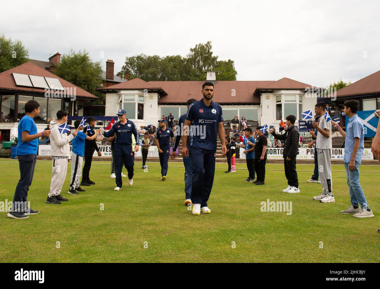 ICC Men's Cricket World Cup League 2 - Scotland v, Nepal. 17th July, 2022. Scotland take on Nepal for the second time in the ICC Div 2 Men's Cricket World Cup League 2 at Titwood, Glasgow. Pic shows: The Scotland team take the field through the guard of honour. Credit: Ian Jacobs/Alamy Live News Stock Photo