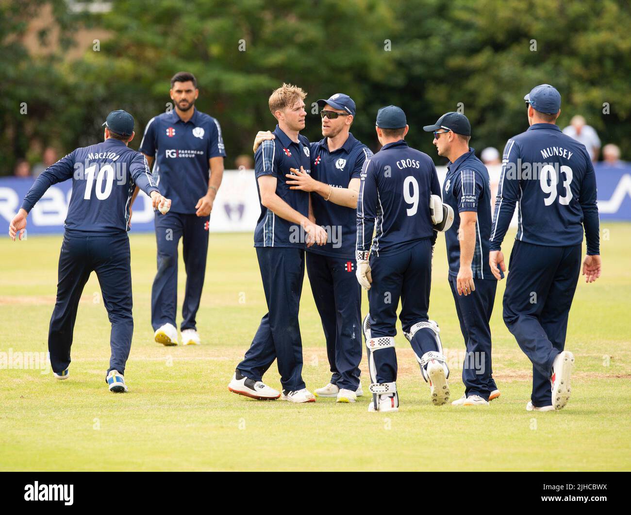 ICC Men's Cricket World Cup League 2 - Scotland v, Nepal. 17th July, 2022. Scotland take on Nepal for the second time in the ICC Div 2 Men's Cricket World Cup League 2 at Titwood, Glasgow. Pic shows: Scotland's Gavin Main is is mobbed by teammates after dismissing NepalÕs Dev Khanal for 10 runs. Credit: Ian Jacobs/Alamy Live News Stock Photo