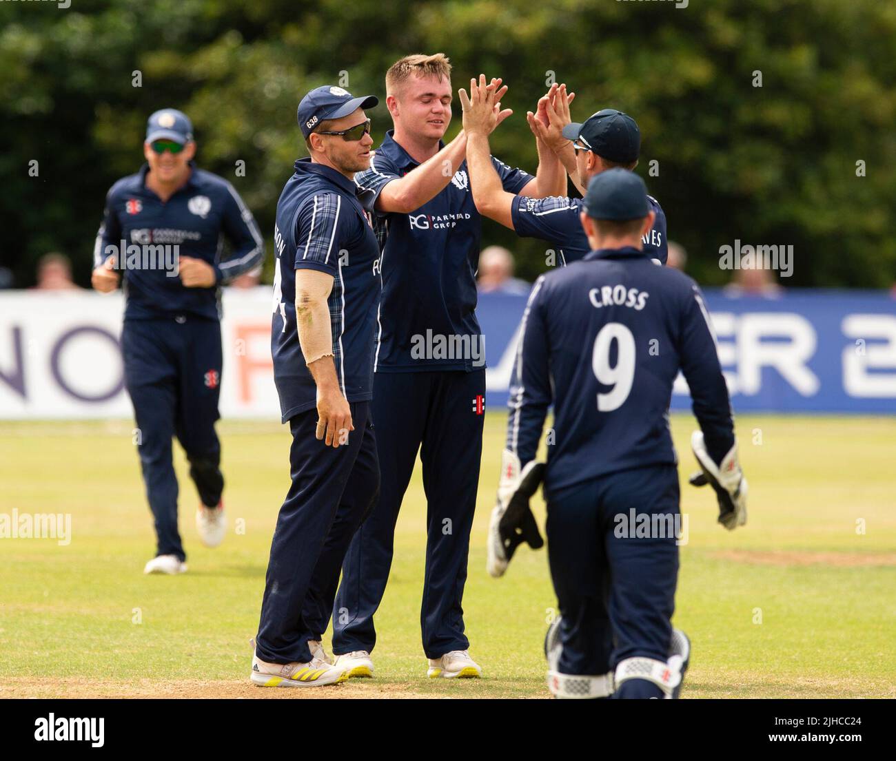 ICC Men's Cricket World Cup League 2 - Scotland v, Nepal. 17th July, 2022. Scotland take on Nepal for the second time in the ICC Div 2 Men's Cricket World Cup League 2 at Titwood, Glasgow. Pic shows: Scotland's Chris McBride is mobbed by teammates after taking his first international wicket by dismissing NepalÕs Rohit Paudel for 10 runs Credit: Ian Jacobs/Alamy Live News Stock Photo