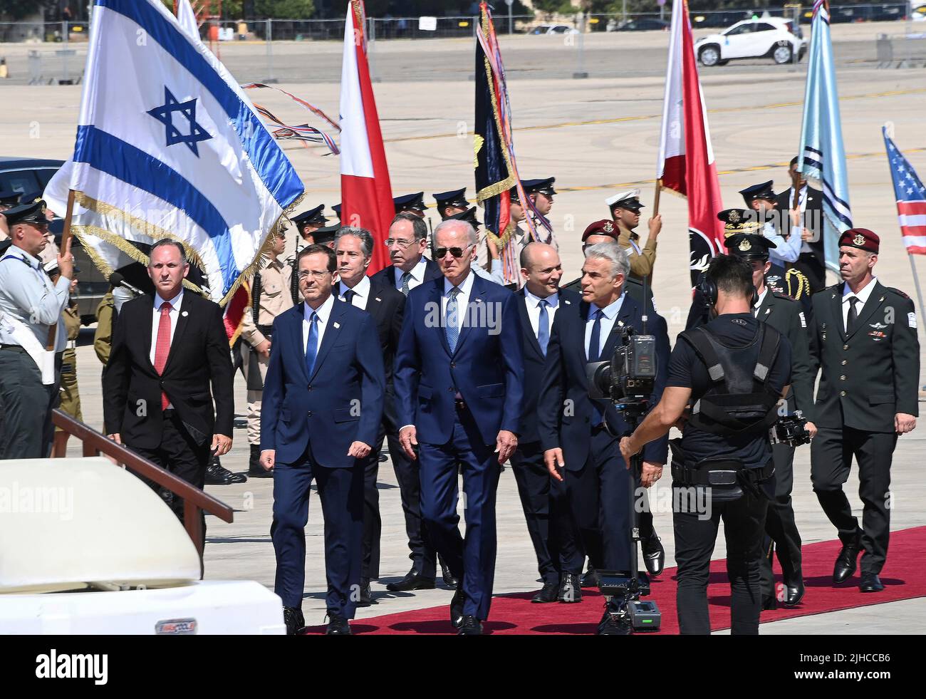 Tel Aviv, Israel. 13 July, 2022. U.S President Joe Biden, center, is welcomed on arrival by Israeli Prime Minister Yair Lapid, right, and Israeli President Isaac Herzog, left, at Ben Gurion Airport, July 13, 2022 in Tel Aviv, Israel. Stock Photo