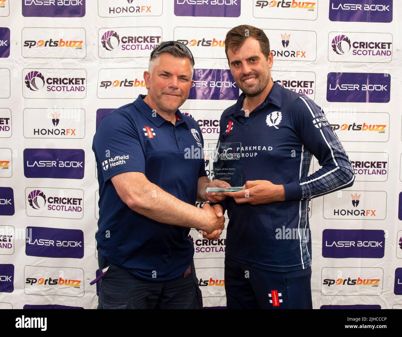 ICC Men's Cricket World Cup League 2 - Scotland v, Nepal. 17th July, 2022. Scotland take on Nepal for the second time in the ICC Div 2 Men's Cricket World Cup League 2 at Titwood, Glasgow. Pic shows: Scotland's Calum MacLeod receives the player of the match award from Cricket Scotland Board member, Colin Mitchell. Credit: Ian Jacobs/Alamy Live News Stock Photo