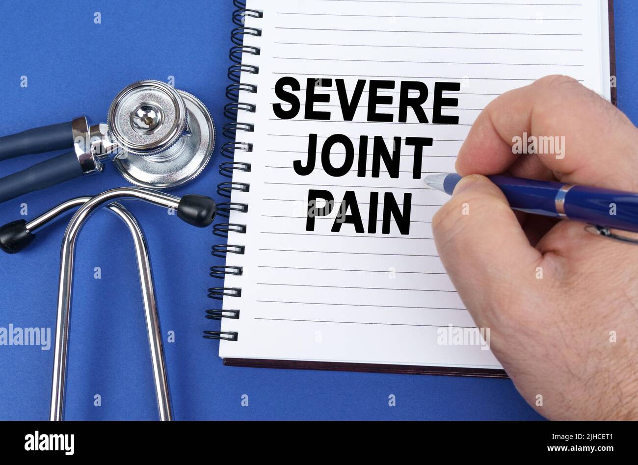 Medical concept. On a blue surface lies a stethoscope and a notebook in ...