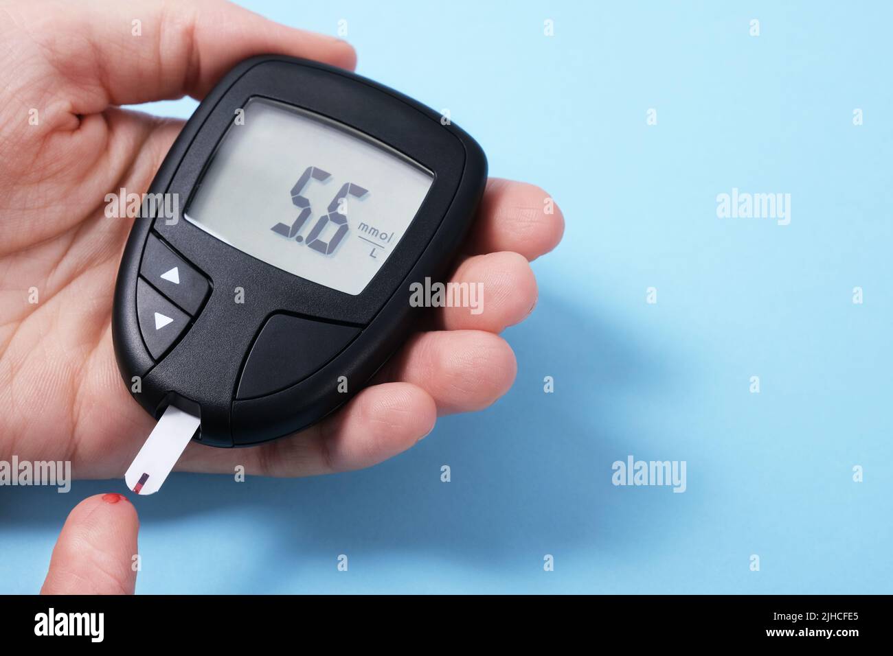 Woman using checking blood sugar level. Diabetes concept on