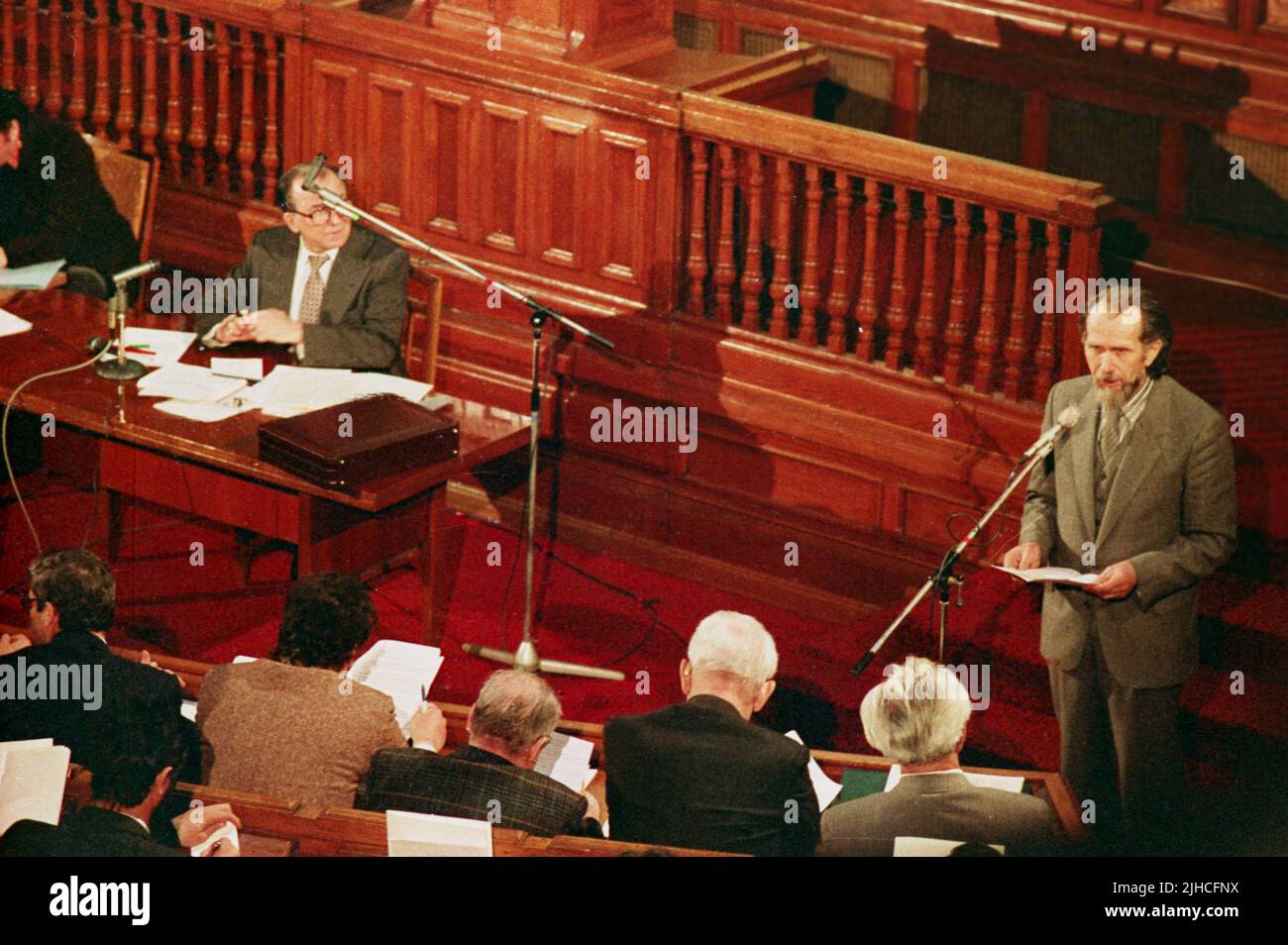 Bucharest, Romania, 1990. The Romanian writer and politician Toma George Maiorescu speaking in the Romanian Parliament as the leader of the newly formed party M.E.R. Presiding the session, Ion Iliescu, provisional president of Romania right after the Romanian Revolution of 1989. Stock Photo