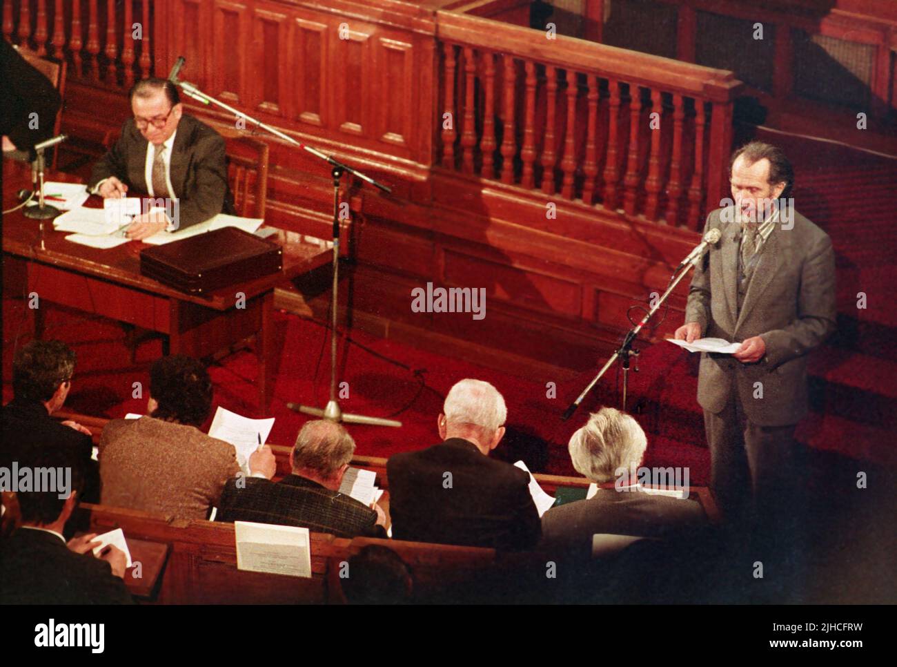 Bucharest, Romania, 1990. The Romanian writer and politician Toma George Maiorescu speaking in the Romanian Parliament as the leader of the newly formed party M.E.R. Presiding the session, Ion Iliescu, provisional president of Romania right after the Romanian Revolution of 1989. Stock Photo