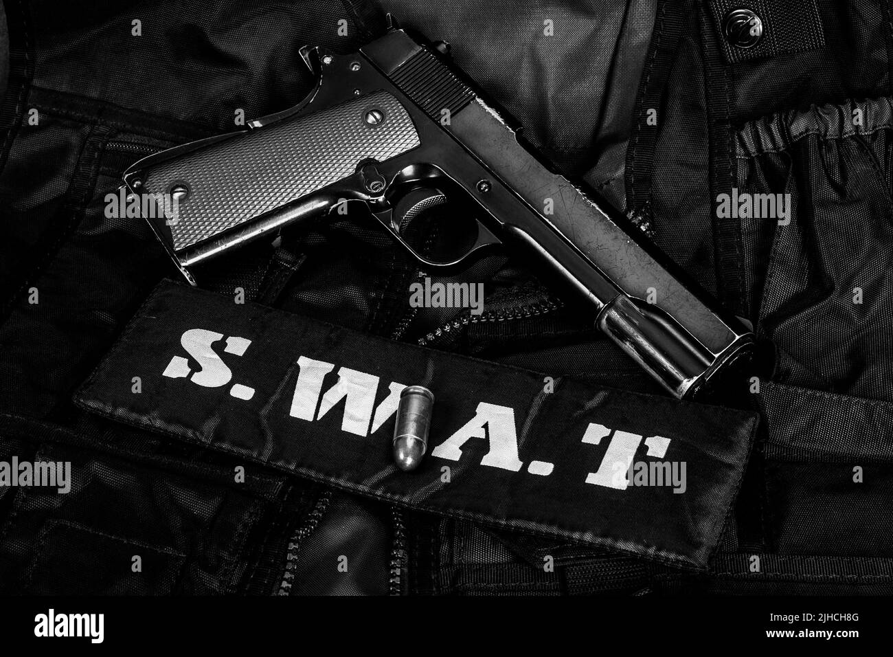 SWAT (Special weapons and tactics) team equipment with hand gun on black uniform background Stock Photo