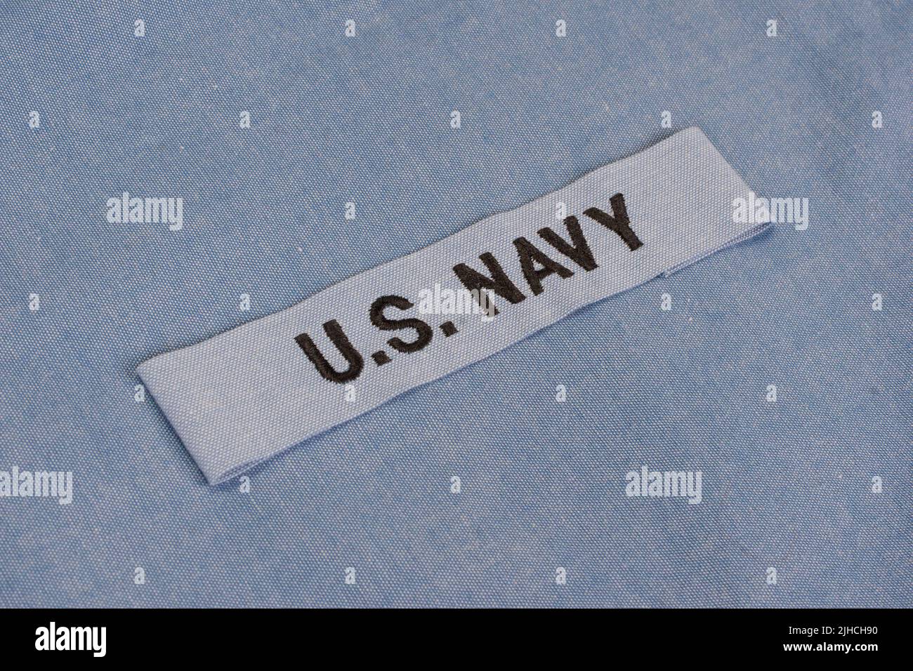 US NAVY branch tape on navy blue uniform background Stock Photo