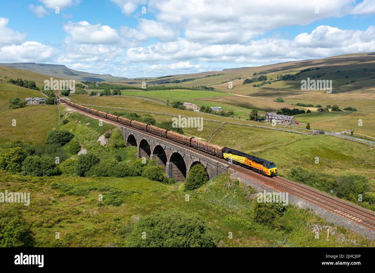 Colas Class 70808 heads the 12.57 Carlisle to Chirk Log Train crossing Lunds Viaduct on the Settle and Carlisle Railway. 13th July 2022 Stock Photo