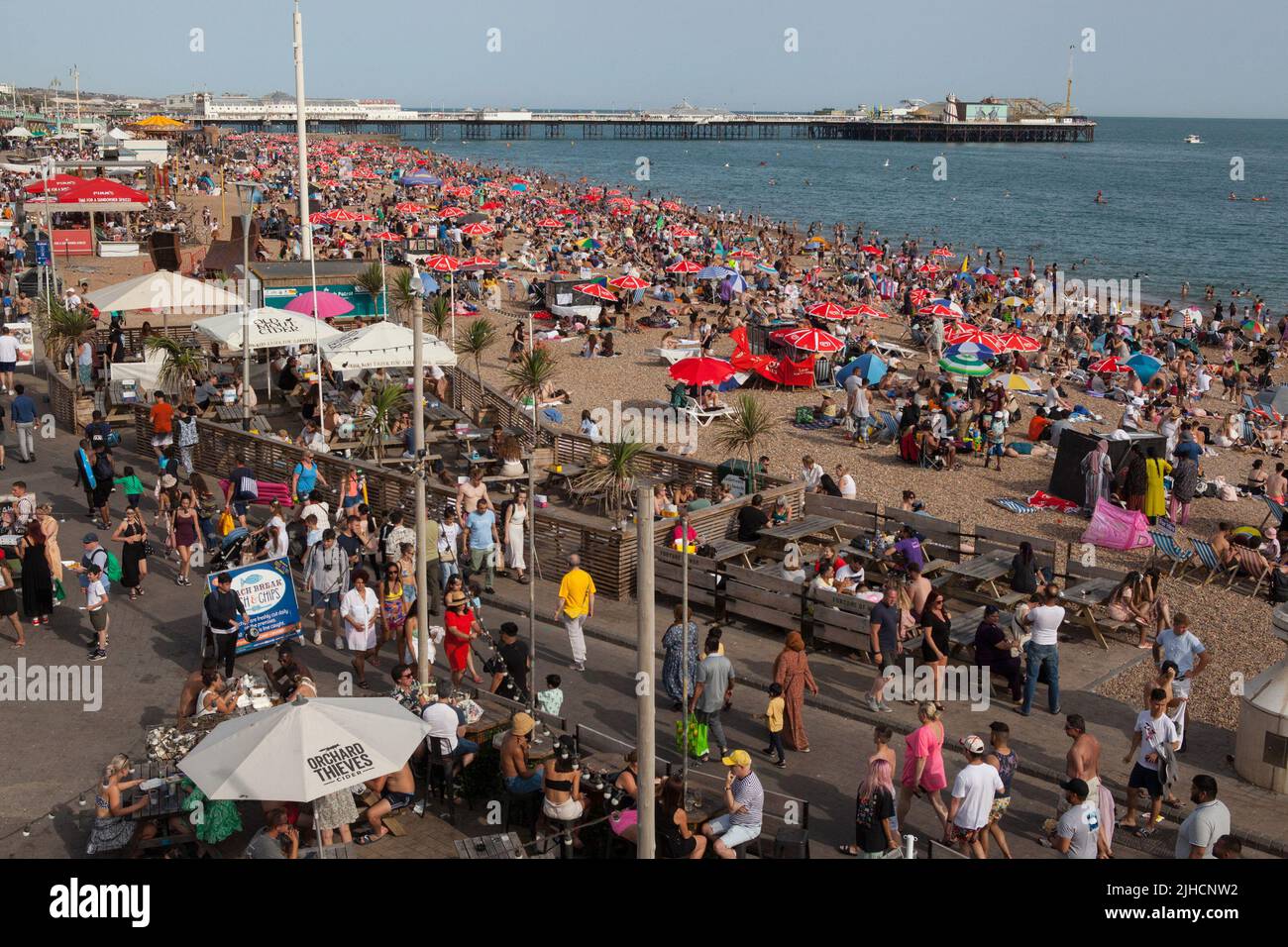A crowded beach on Brighton seafront Stock Photo