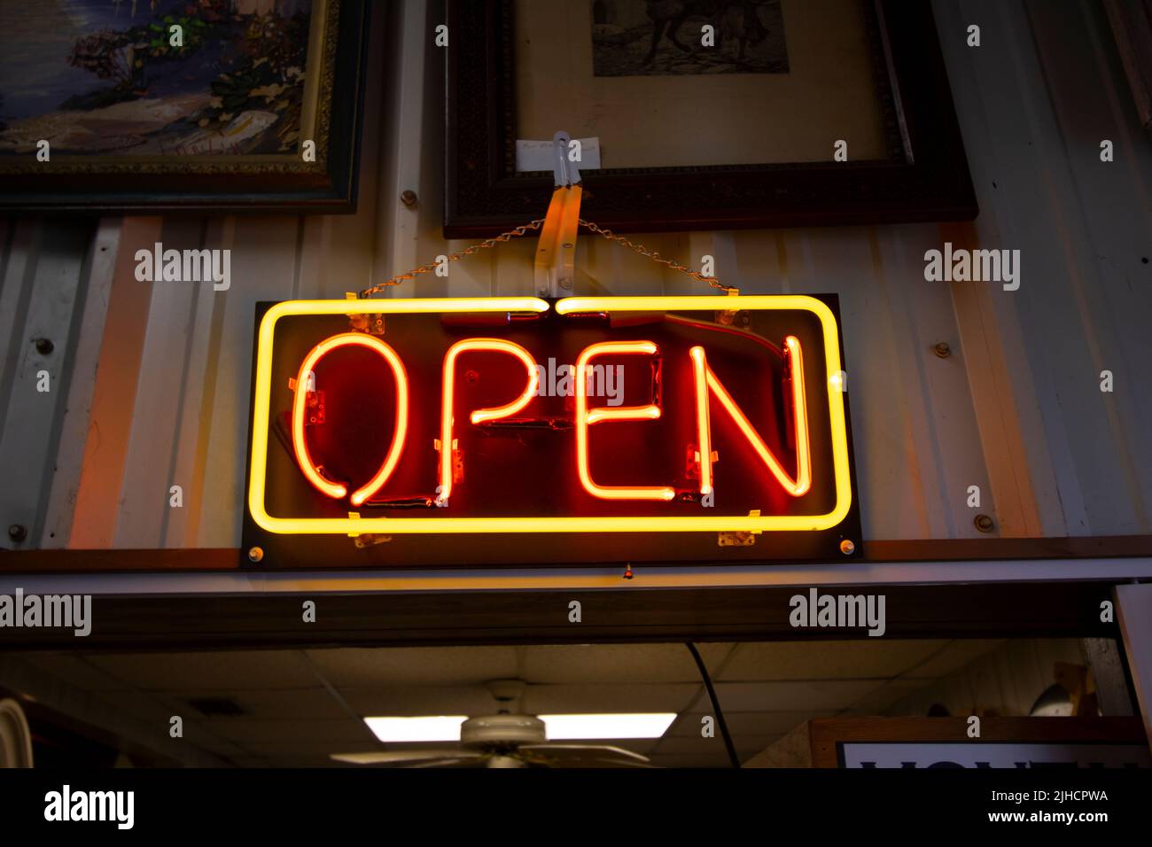 Bright neon Open sign above a vintage store entrance Stock Photo