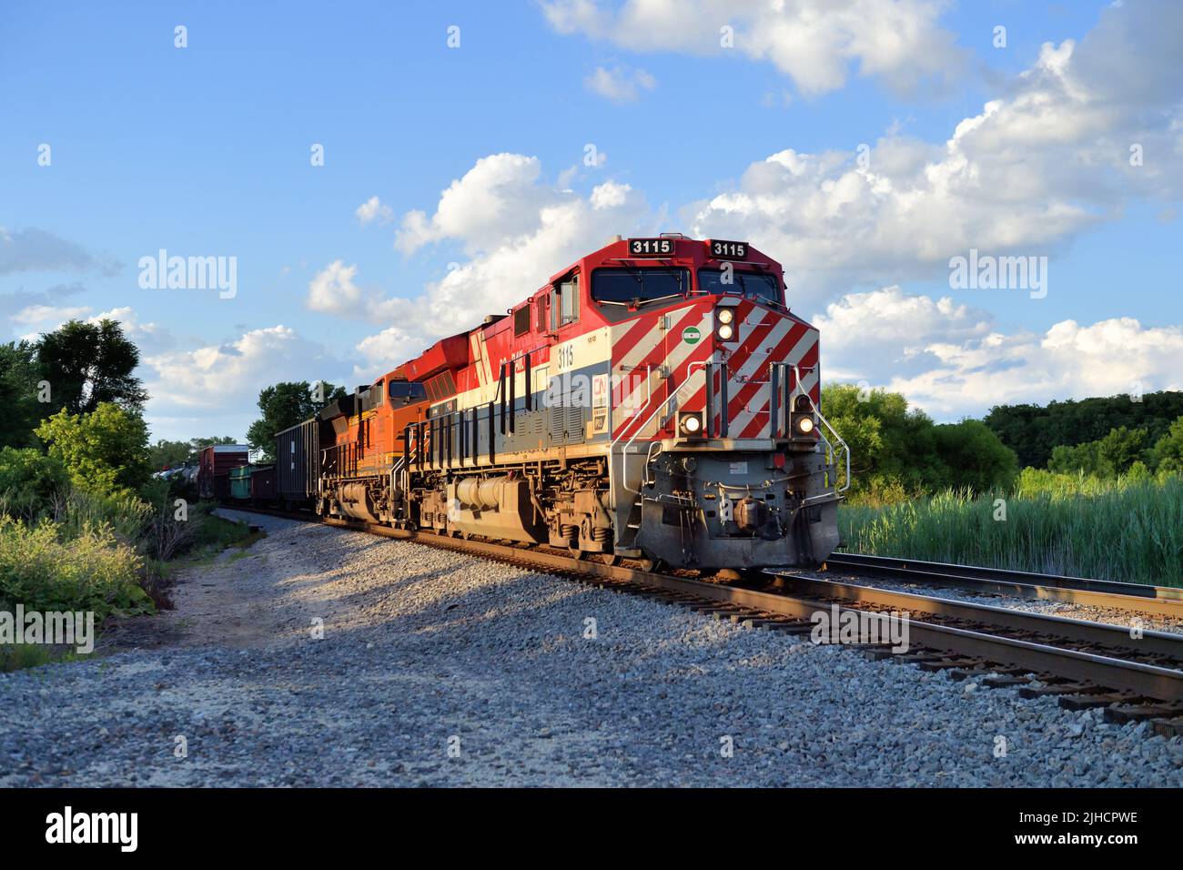 Hoffman Estates, Illinois, USA.  A Canadian National Railway heritage locomotive unit painted for the British Columbia Railway leading a freight train. Stock Photo