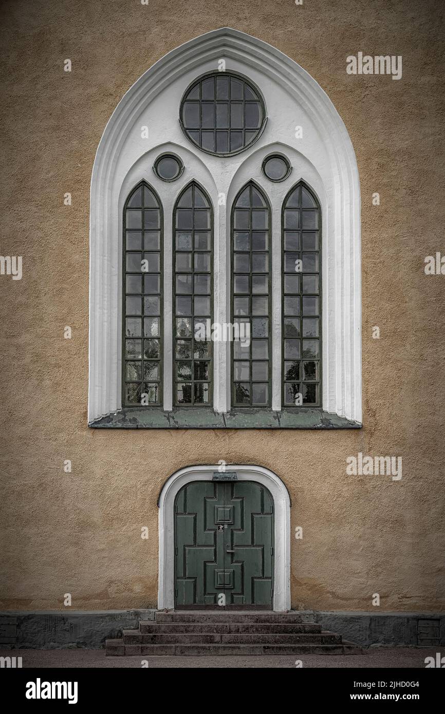 A vertical shot of the Broby Swedish Parish Church door and window in Scania, Sweden Stock Photo