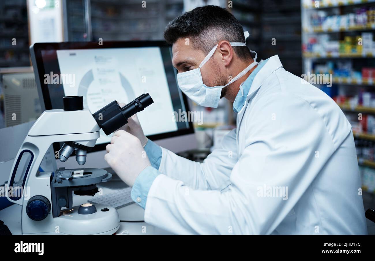 The leader in cutting edge pharmaceutical research. a mature man using a microscope while conducting pharmaceutical research. Stock Photo
