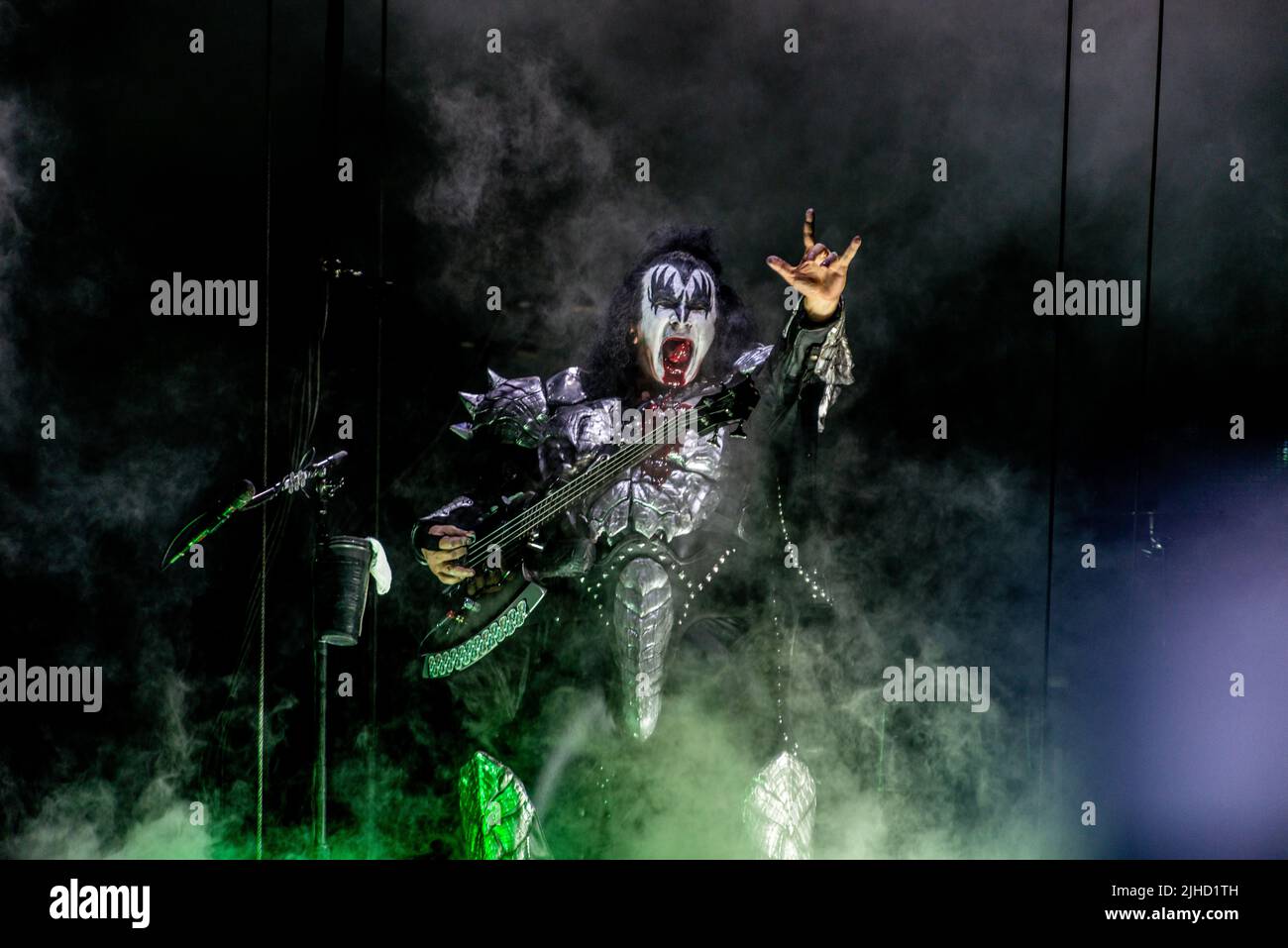 Gene Simmons in his classic Kiss outfit. Holding upp his hand with the three fingers rock hand and very bloody mouth. Stock Photo