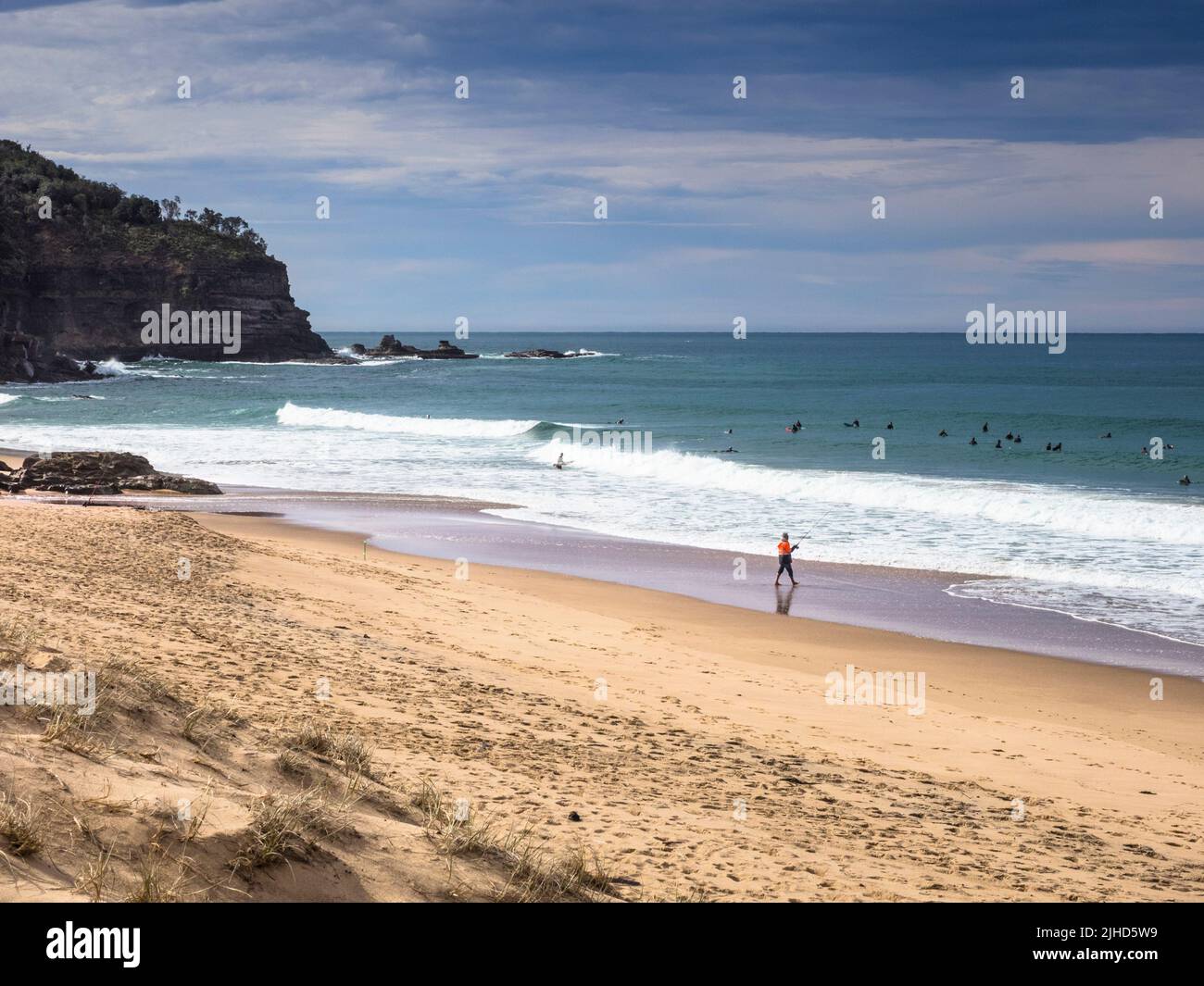 Surfers catching the winter swell at Stanwell Park Beach just south of Sydney in the Illawarra Region. New South Wales. Stock Photo