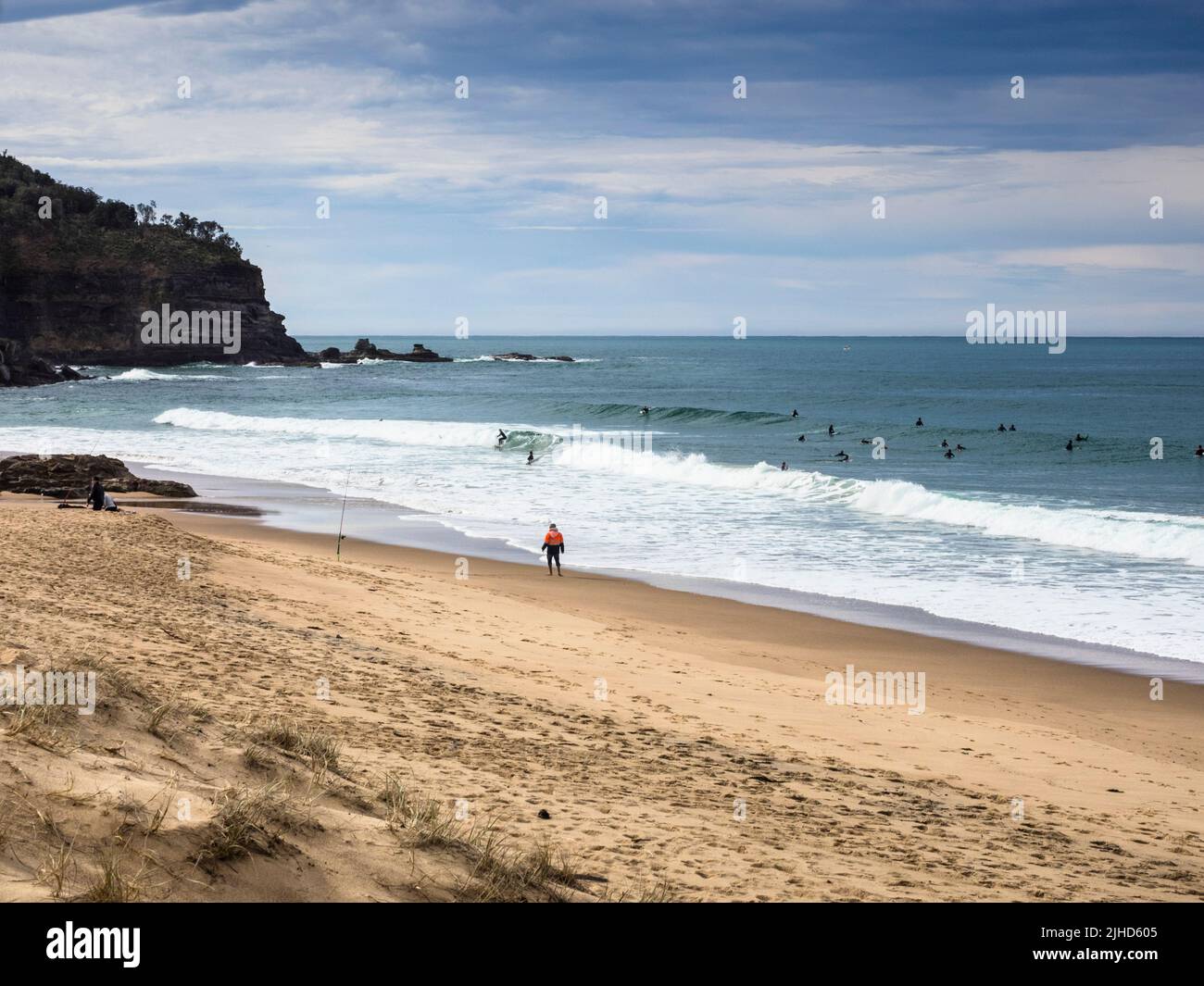 Surfers catching the winter swell at Stanwell Park Beach just south of Sydney in the Illawarra Region. New South Wales. Stock Photo
