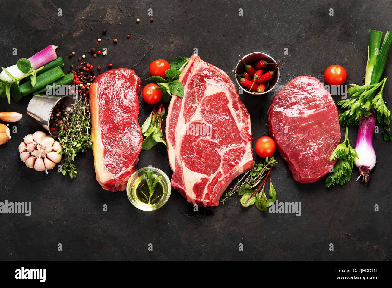 Variety of raw beef meat steaks for grilling with seasoning and