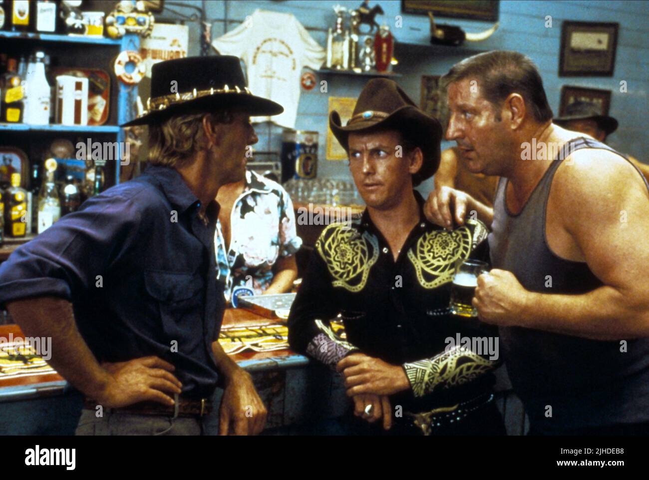 PAUL HOGAN, GERRY SKILTON, STEVE RACKMAN , CROCODILE DUNDEE, 1986 Stock Photo