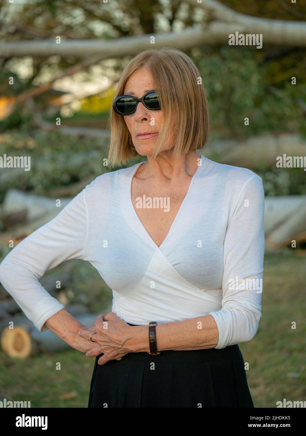 senior fit elegant lady dressed blaka dn white wearing sunglasses enjoying nature in summer Stock Photo