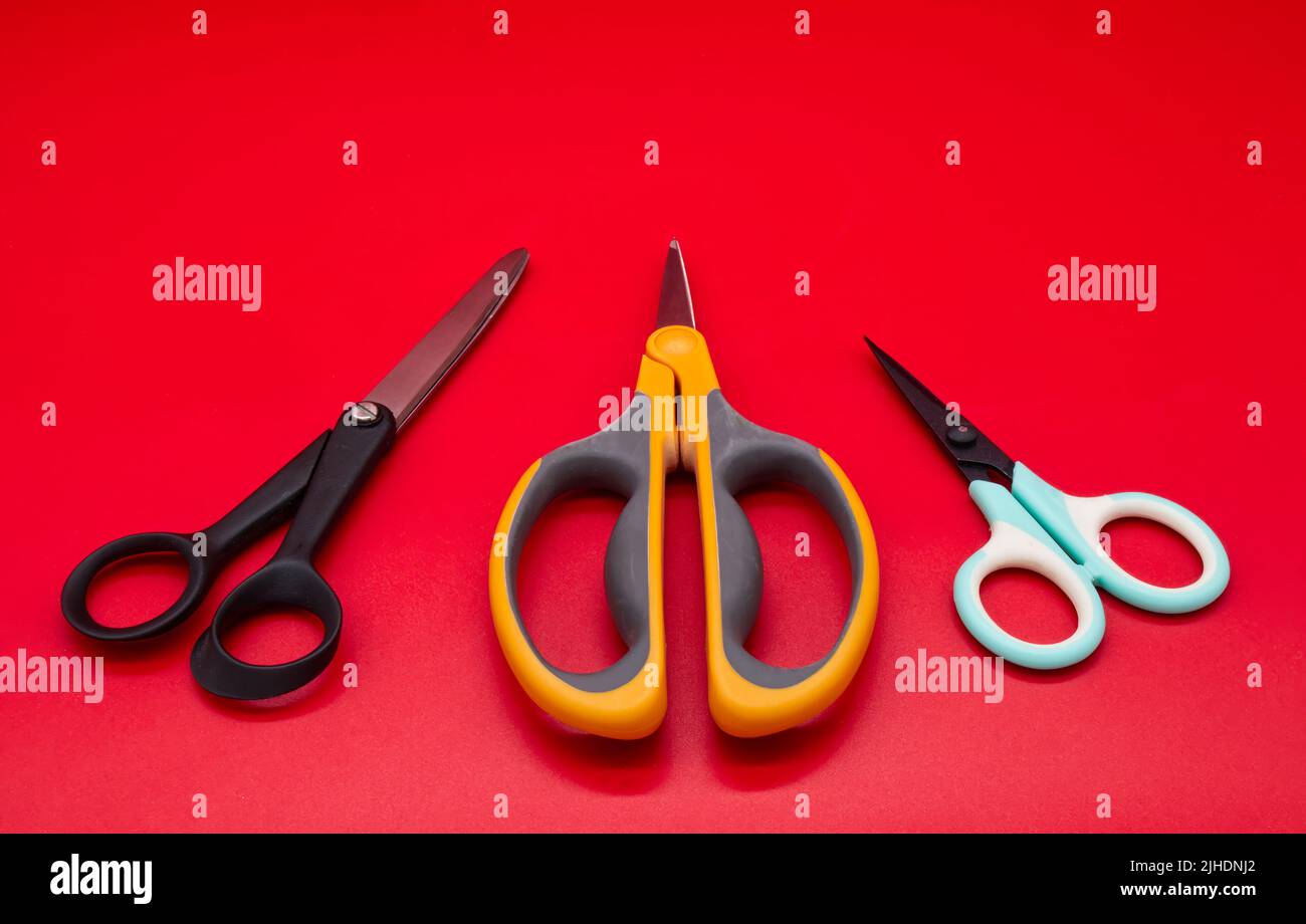 Different shape scissors isolated on red background Stock Photo Alamy
