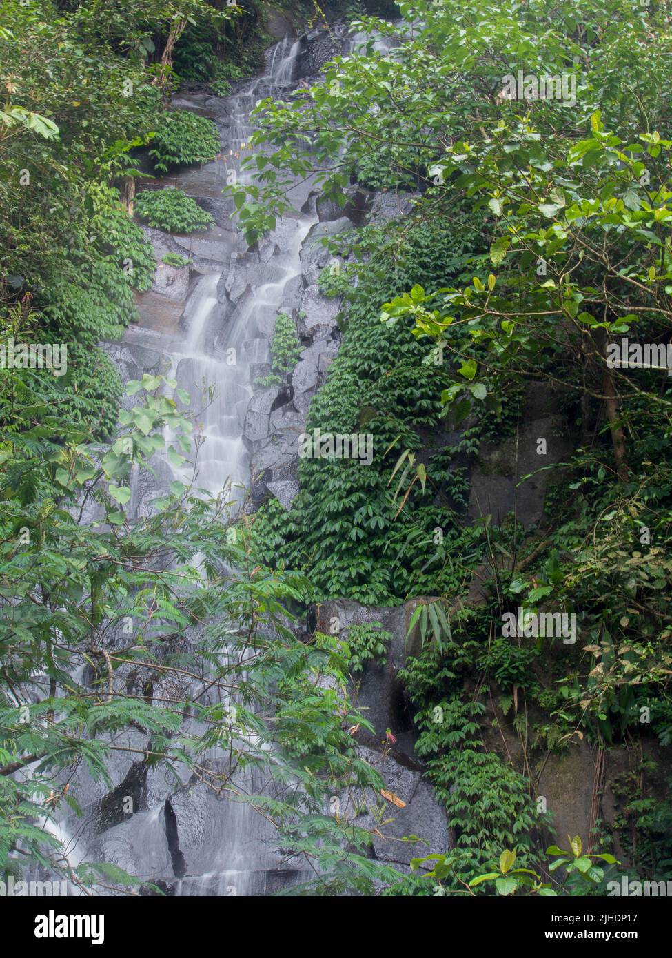 a waterfall flows quietly from a small river on top of a mountain Stock ...