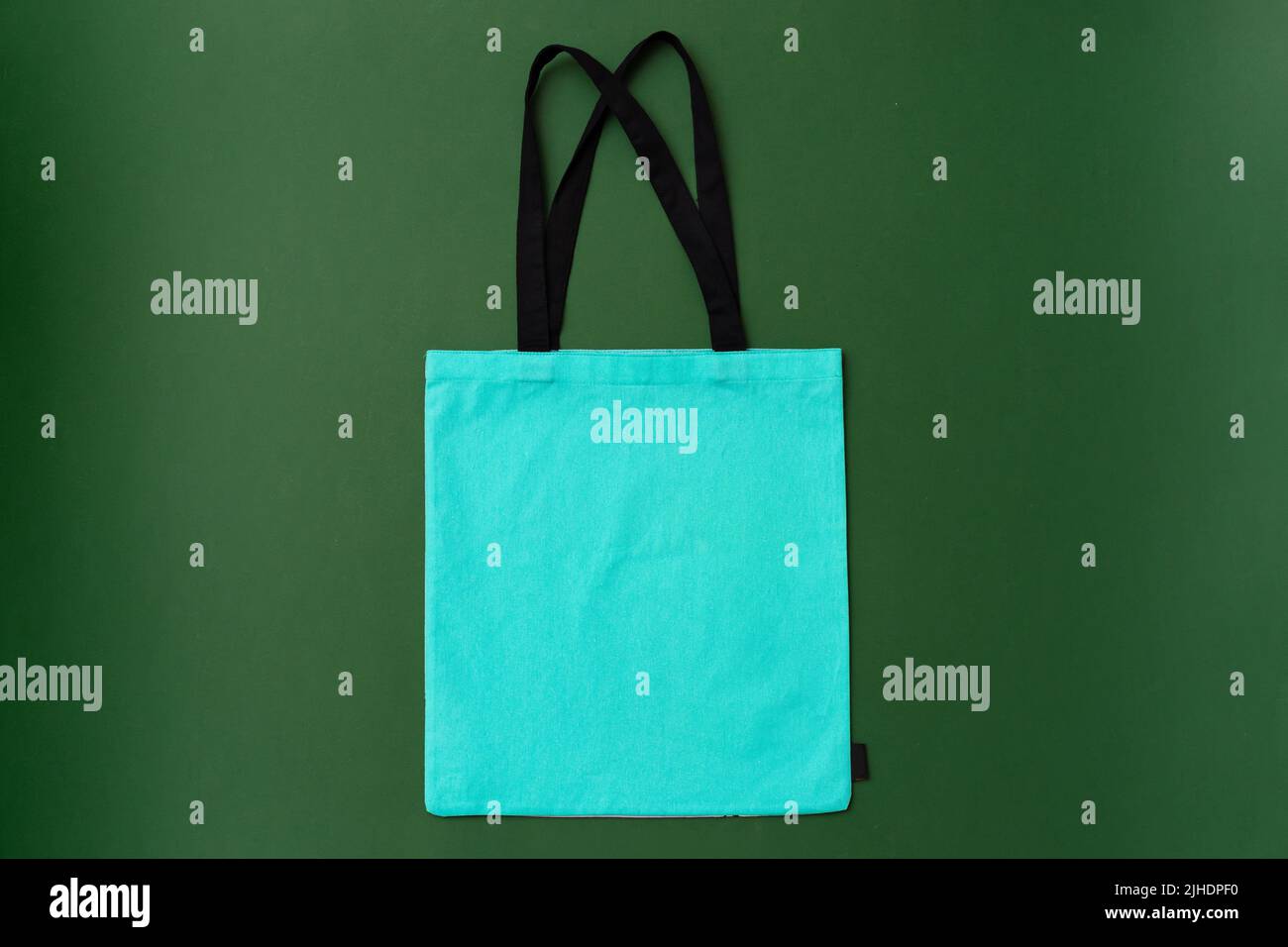 Textile shopping bag on green background flat lay Stock Photo - Alamy