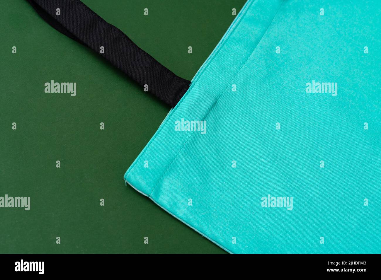 Textile shopping bag on green background flat lay Stock Photo - Alamy