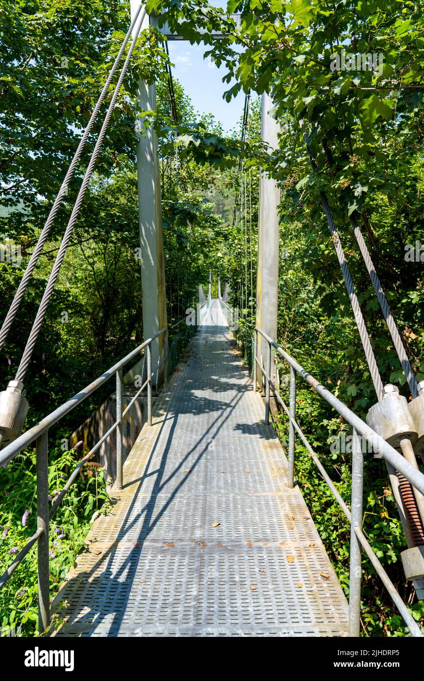 Metal suspension rope bridge in nature. Scenic view. Steel footbridge Stock  Photo - Alamy