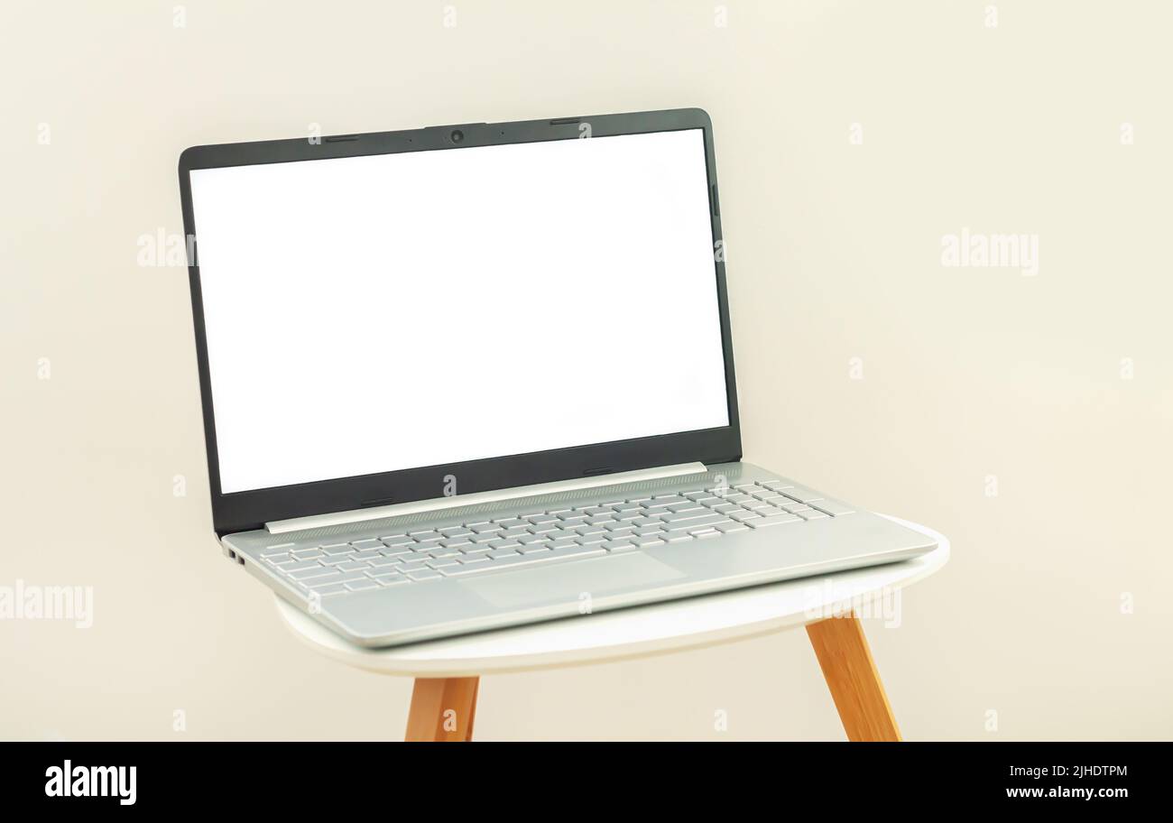 Office workspace with open laptop computer or notebook with blank white ...