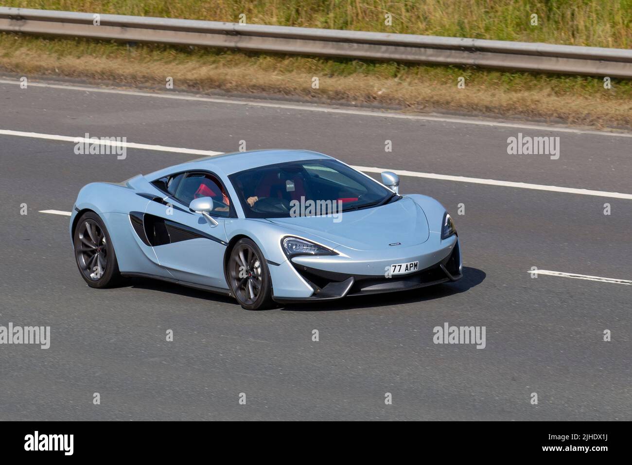 2018 silver blue MCLAREN 540 V8 SSG 3799cc petrol supercar; driving on the M6 Motorway, Manchester, UK Stock Photo