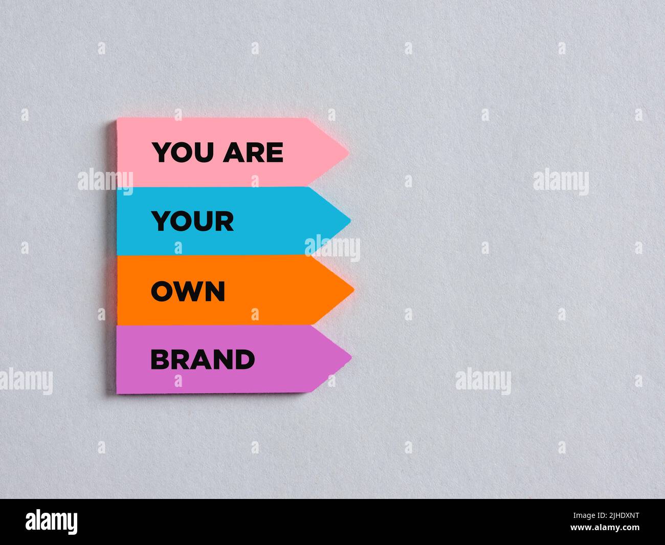 Colorful arrow shaped stickers with the message you are your own brand. Business marketing branding Stock Photo