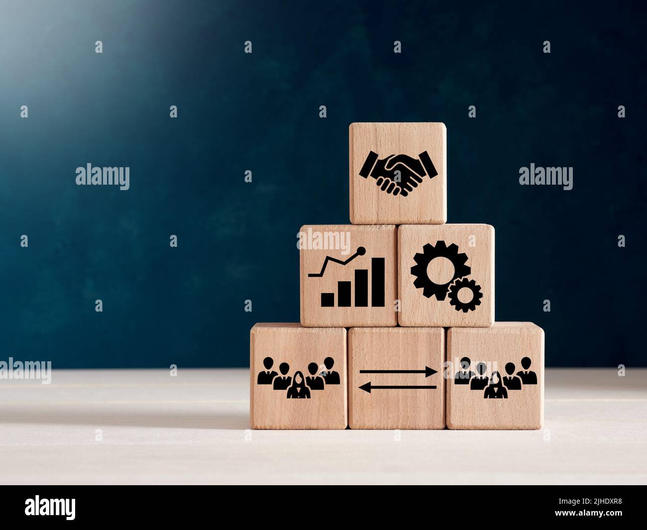 Business agreement, cooperation and efficiency concept. Wooden cube blocks with business agreement icons. Stock Photo