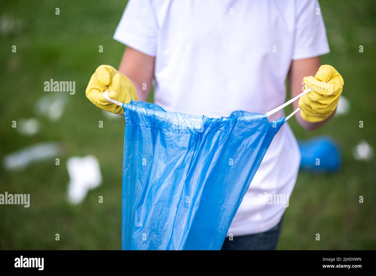 Close up of a kid holding a plastic bag for garbage Stock Photo Alamy