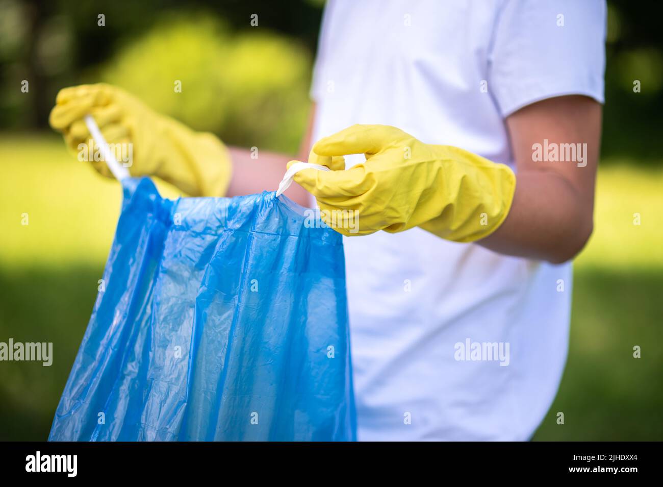 Close up of a kid holding a plastic bag for garbage Stock Photo Alamy
