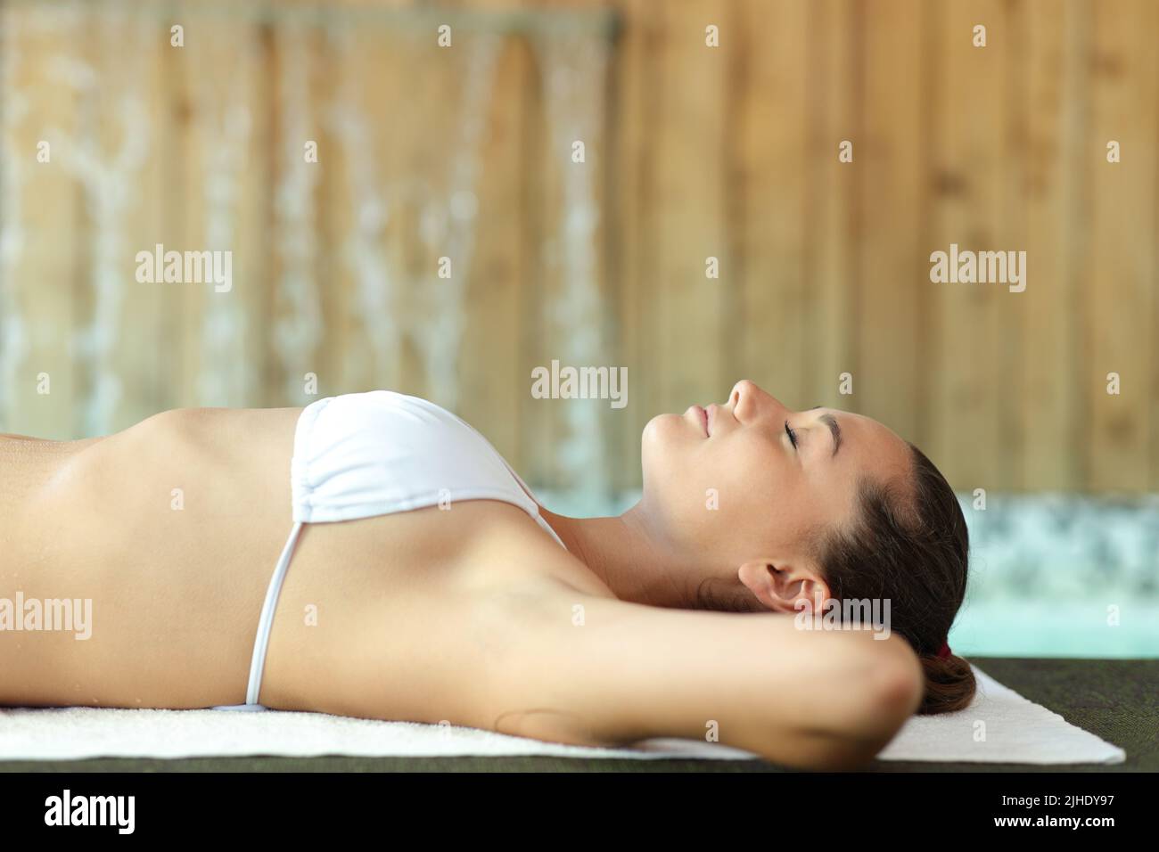 Side view portrait of a woman relaxing lying in the floor of spa Stock Photo