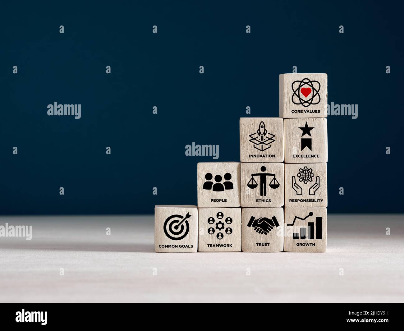 Wooden cubes with core corporate values for goal achievement and business success. Company culture, guiding principles and business strategy concept. Stock Photo