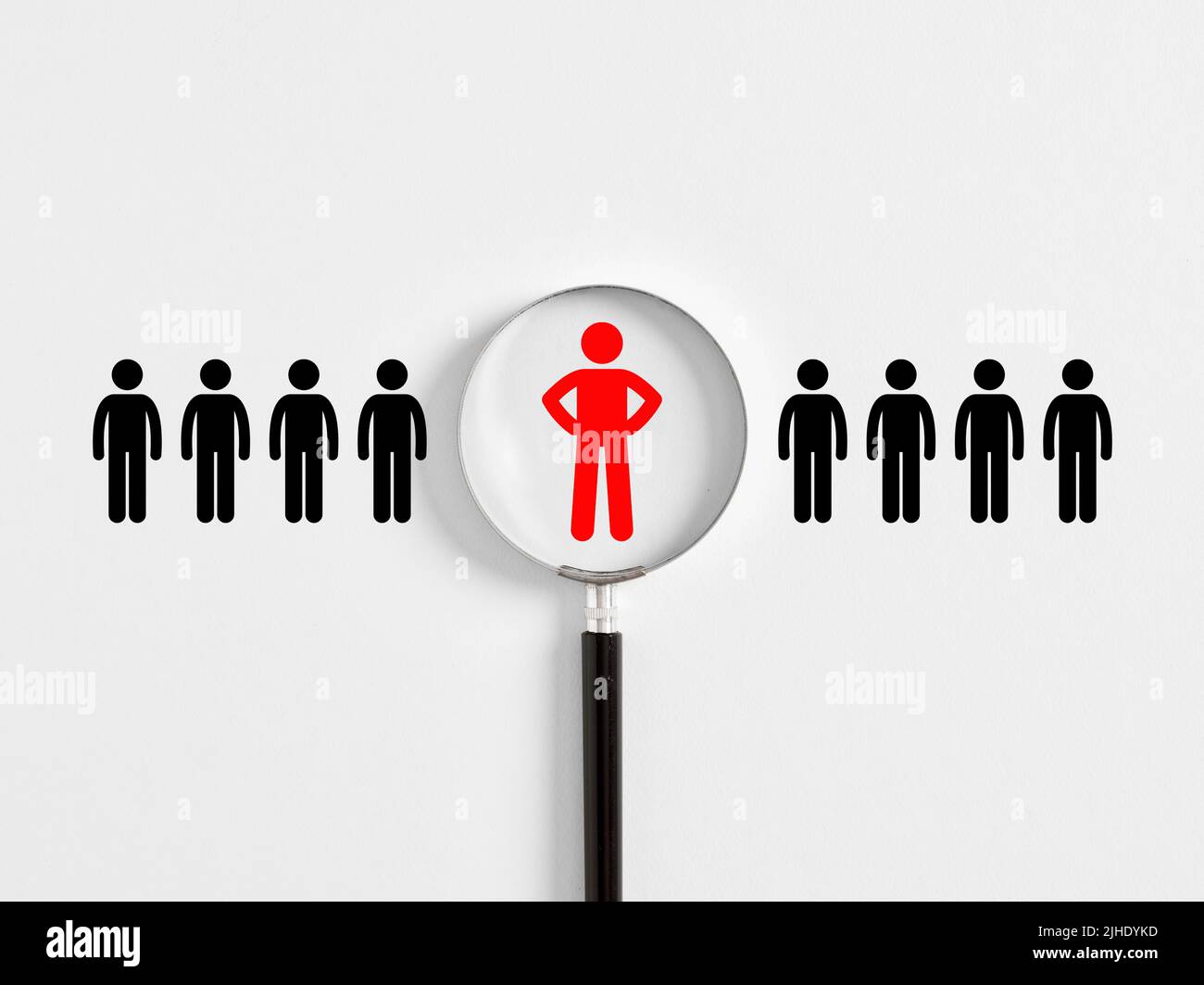 Human resources management, job recruitment or employee search concept. Magnifying glass with employee icons on white background. Stock Photo