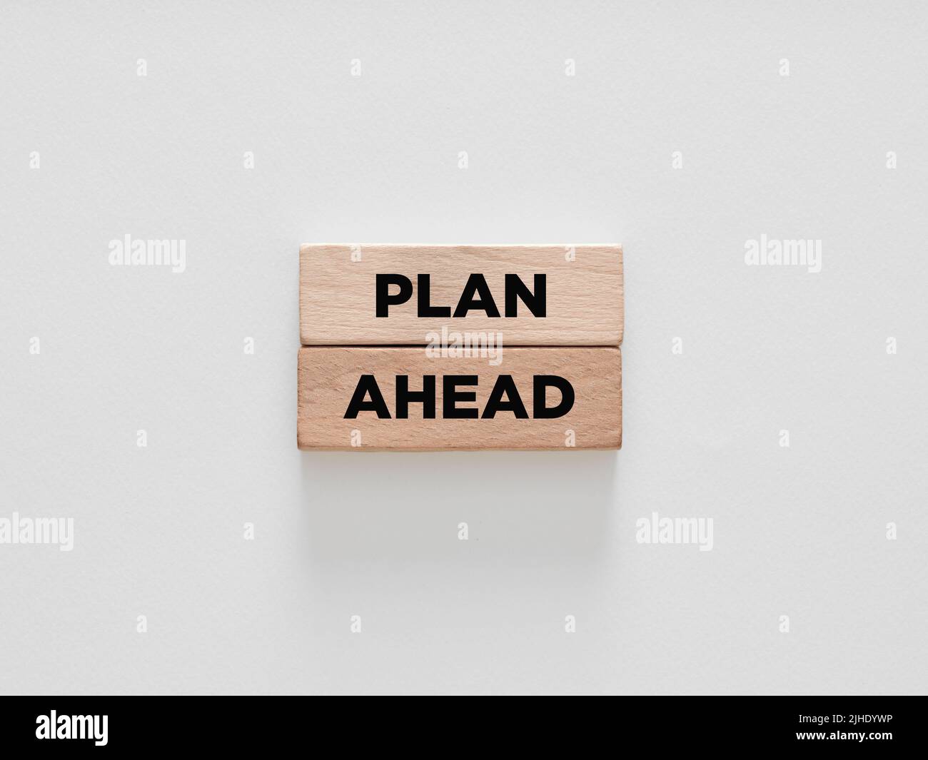 The words plan ahead on wooden blocks on white background. Strategic planning for business or education concept. Stock Photo