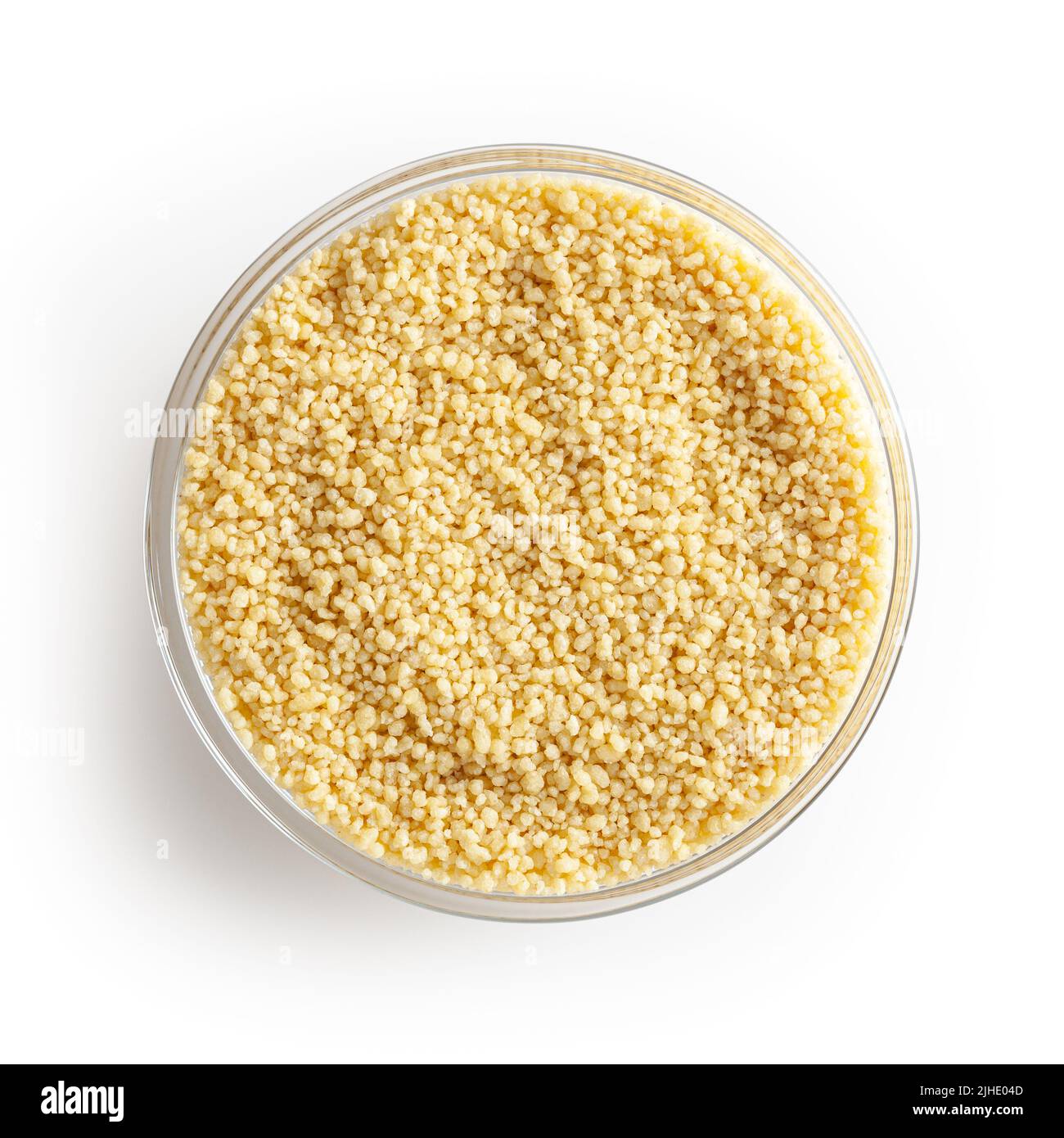 Dry couscous in glass bowl isolated on white background with clipping