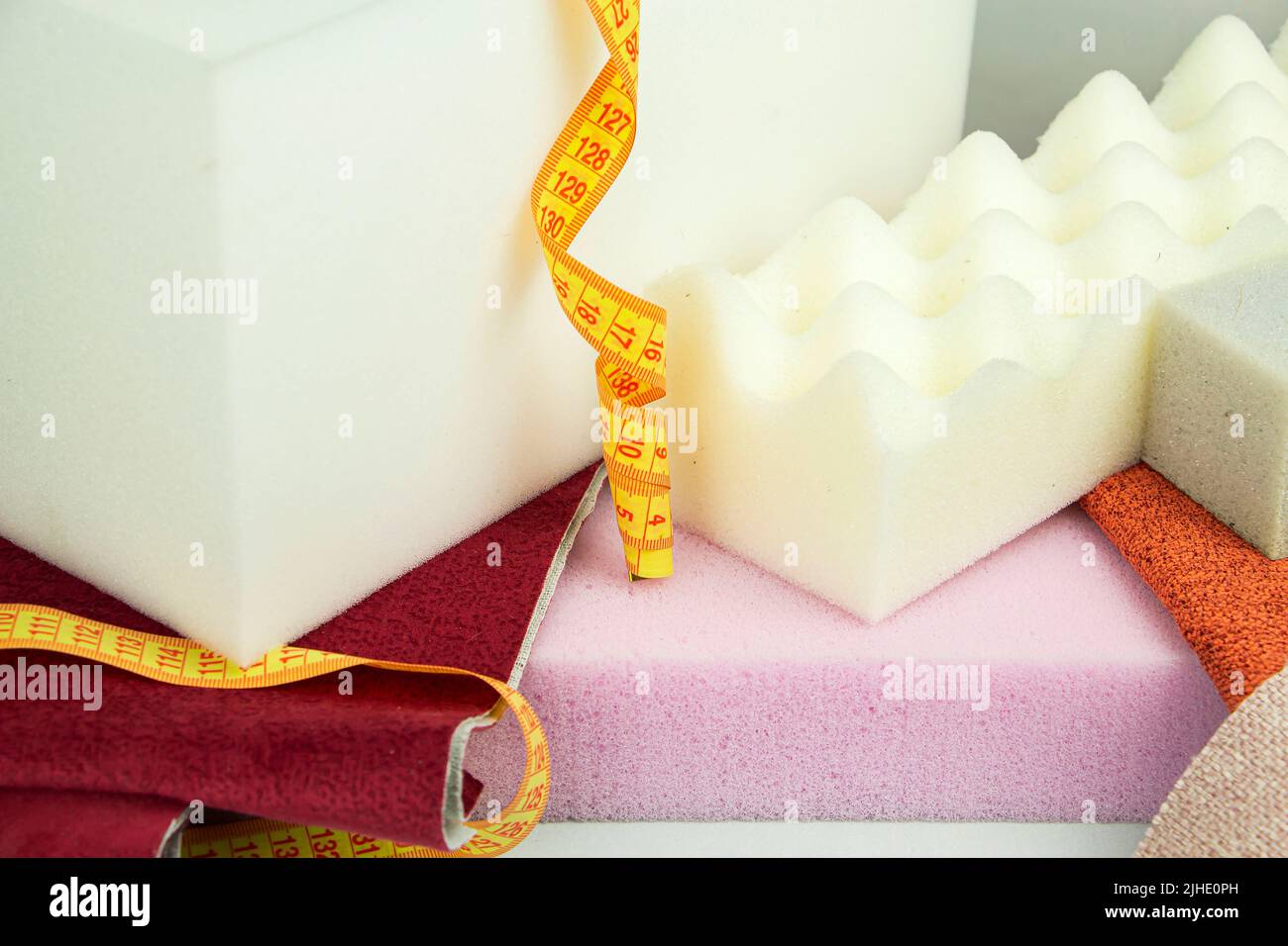 a piece of foam rubber of different sizes and colors, production of upholstered furniture Stock